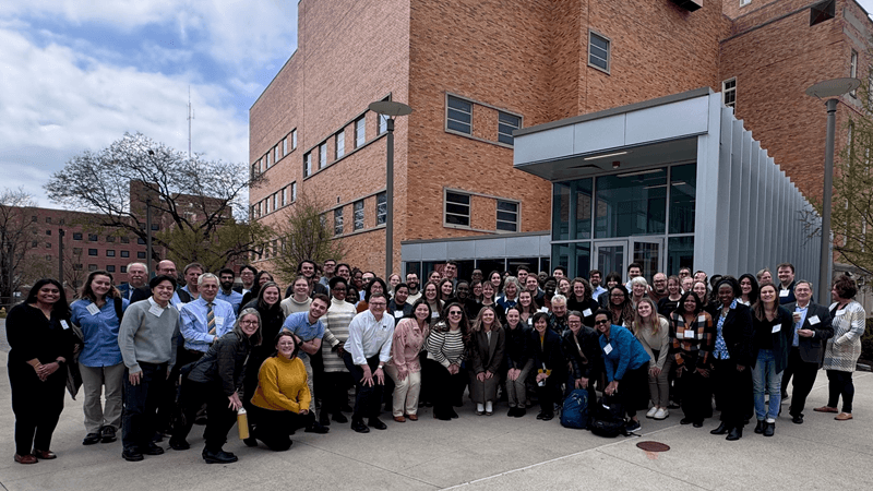 large group of people outside of a college building