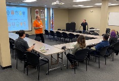 people in a classroom listening to a speaker