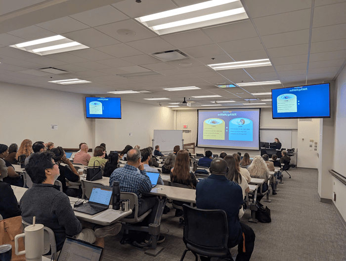 People in an auditorium watching a presentation