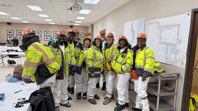 group of people in hard hats and safety vests