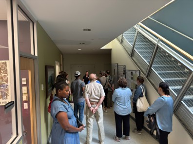 people standing in a hallway listening to a speaker