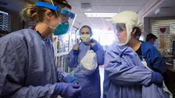 three healthcare workers in scrubs