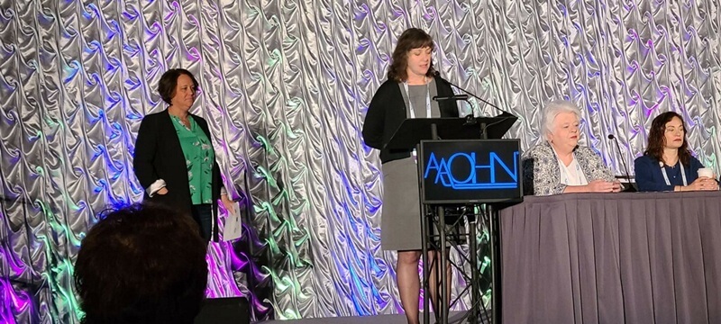 person speaking at a podium