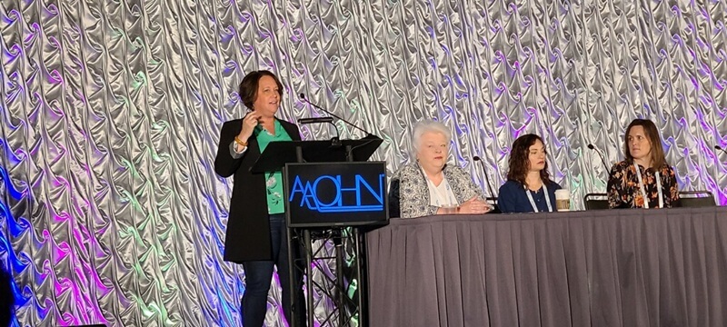 person speaking at a podium