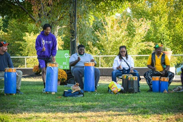 group of people doing drum circle at Schmidlapp Lawn during Blink Cincinnati 2024
