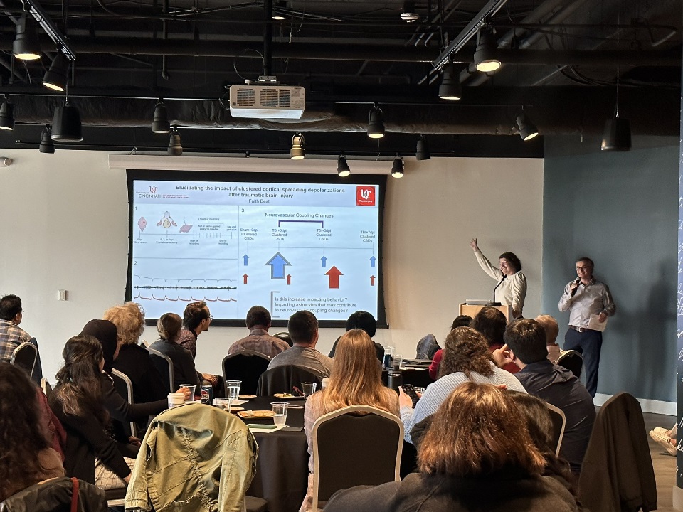5th year student presenting three minute thesis with director introducing student