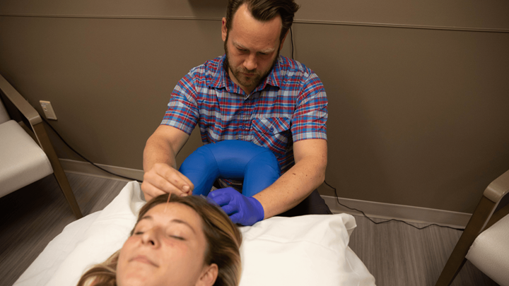 acupuncturist providing acupuncture to patient