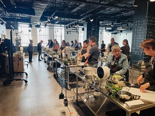 group of people cooking during the food as medicine series at the create culinary studio at the cincinnati museum center
