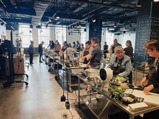 group of people cooking during the food as medicine series at the create culinary studio at the cincinnati museum center