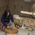 A woman playing an instrument leading sound immersion