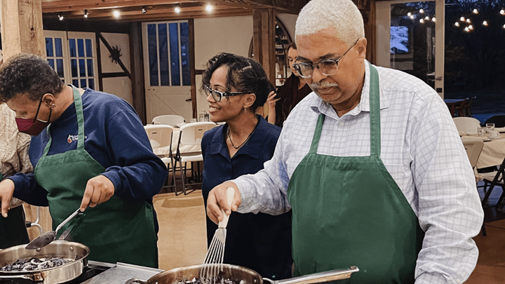 Pamela Sharpe helping participants at a teaching kitchen event