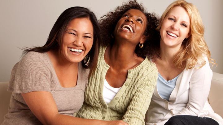 Three women laughing together