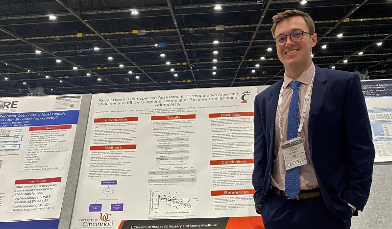 Jorge Figueras in front of poster
