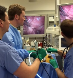 Residents looking at a screen during surgery